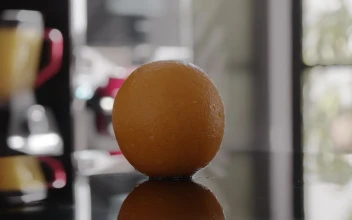 Stock Video Orange Spinning On A Table