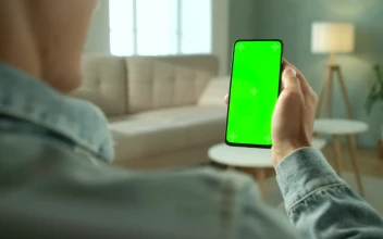 Stock Video Over Shoulder View Of A Man Holding A Green Screen