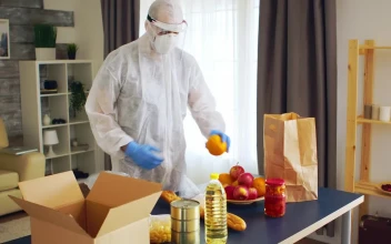 Stock Video Packing Groceries In Ppe For Coronavirus Safety