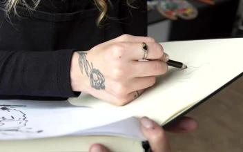 Stock Video Painter Draws In Sketchbook In Art Studio