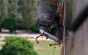 Stock Video Painter Repairing The External Wall Of A Building