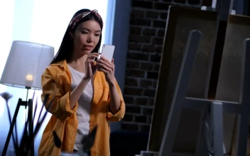Stock Video Painter Taking A Picture Of A Painting