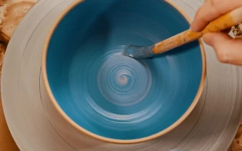 Stock Video Painting A Spinning Pot Blue Using A Brush