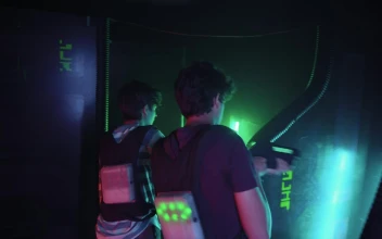 Stock Video Pair Of Guys Playing Laser Tag Together