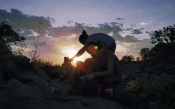 Stock Video Pair Of Mountaineers Putting Away Their Things At Sunset