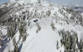 Stock Video Panorama Of A Snowy Mountain With Skiers