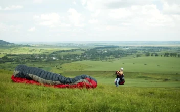 Stock Video Paraglider Lifts Off Over Open Field