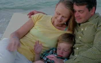 Stock Video Parents Laying With Their Tired Child