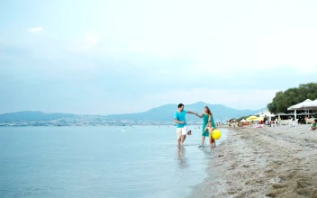 Stock Video Parents Running Along The Coast