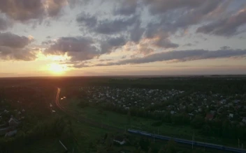 Stock Video Passenger Train Heading Out At Sunset