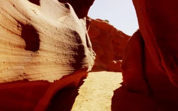 Stock Video Passing Between Rock Formations In The Desert