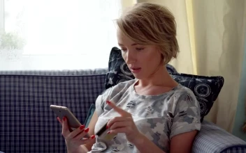 Stock Video Paying On Her Phone Using A Credit Card