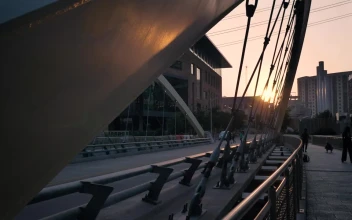 Stock Video Pedestrian Bridge In A City At Sunset