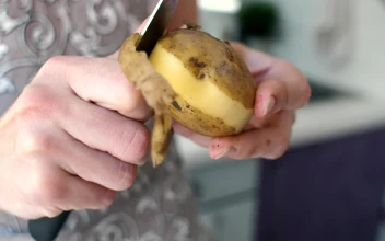 Stock Video Peeling A Potato With A Knife