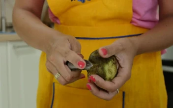Stock Video Peeling Potatoes In The Kitchen For Dinner