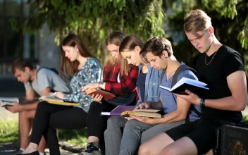Stock Video People In A Garden Studying With Books In Hand