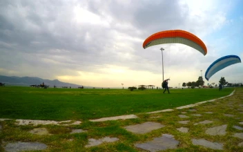 Stock Video People Practicing Parachuting On A Cloudy Day