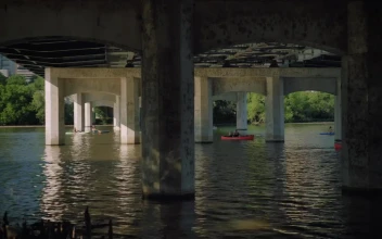 Stock Video People Sailing In A Motorboat Under A Bridge