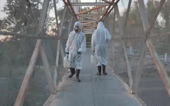 Stock Video People With Masks Sanitizing A Pedestrian Bridge