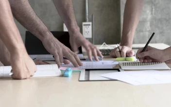 Stock Video Peoples Hands On A Table In A Business Meeting