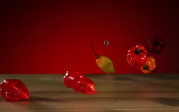 Stock Video Peppers Falling And Bouncing On A Wooden Table
