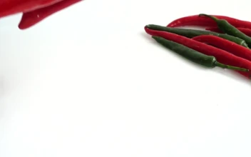 Stock Video Peppers Falling Into Water And Splashing