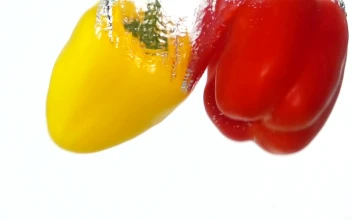 Stock Video Peppers Falling Through Water