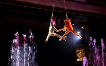 Stock Video Performer Spinning Above Bright Fountains