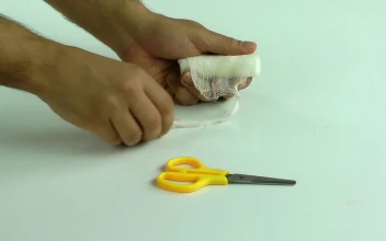 Stock Video Person Bandaging Himself The Hurt Hand