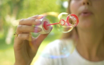 Stock Video Person Blowing Soap Bubbles In The Outside