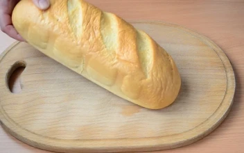 Stock Video Person Cutting Bread On A Board