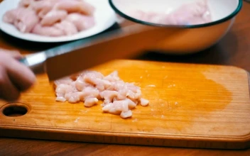 Stock Video Person Cutting Meat Into Small Pieces