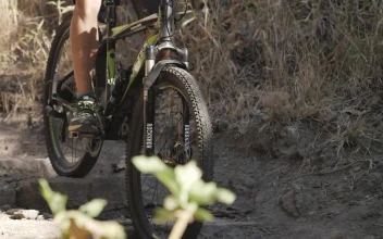 Stock Video Person Cycling Down A Rocky Slope