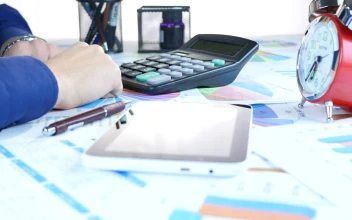 Stock Video Person Doing Accounts And Graphs On A Table