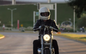 Stock Video Person Driving A Motorcycle On A Lonely Street