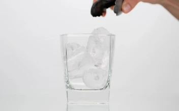 Stock Video Person Fills A Glass With Cola On White Background