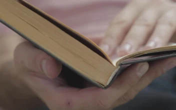 Stock Video Person Flipping Through A Book Looking For A Page