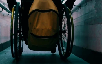 Stock Video Person In A Wheelchair Sliding Down A Narrow Slope