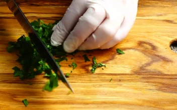 Stock Video Person In Gloves Cutting Parsley