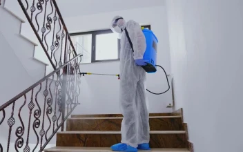 Stock Video Person In Ppe Sanitizing Building During Pandemic