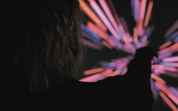 Stock Video Person In The Dark With A Colored Lights Background