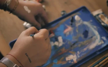 Stock Video Person Mixing Paint On A Table
