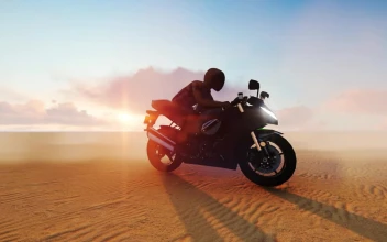 Stock Video Person On A Motorcycle In The Middle Of A Desert