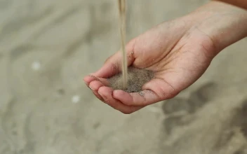 Stock Video Person Passing Sand From One Hand To Another