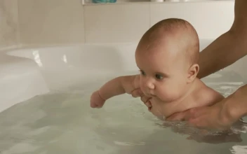 Video Stock Person Puts A Baby In The Bathtub Free