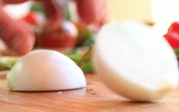 Video Stock Person Slicing Onion On A Board Free