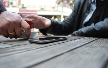 Video Stock Person Using A Mobile Phone While Drinking Tea Free