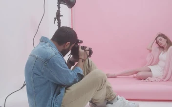 Video Stock Photographer Portraying A Young Woman On A Pink Background Free
