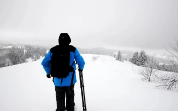 Video Stock Photographer With A Camera And Tripod In The Snow Free