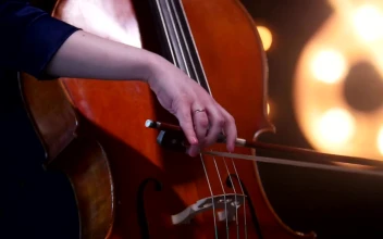 Video Stock Playing The Cello With Blurry Lights In The Background Free